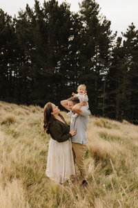 Beautiful family wearing earth tones outfits during a family session in Christchurch
