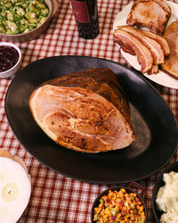 Commercial lifestyle food photography of a holiday smoked ham product for a premium CPG meat brand, created for website PDPs, paid ads, PR, and seasonal marketing campaigns