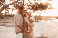 Folly Beach Maternity Photographer -- Pregnant woman poses for Maternity Photos at the Lighthouse Inlet Heritage Preserve on Folly Beach with iconic views of the Morris Island Lighthouse in the distance.