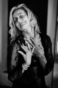 Boudoir experience studio woman running hands down her neck