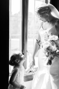Intimate and heartfelt moment between bride and child captured in wedding photography Detroit