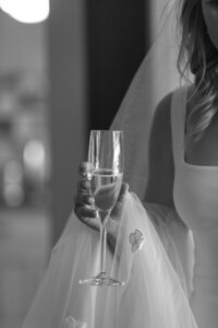 Close up of Bride holding a champagne flute.