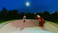 edgy couple skating at blue hour together, new york cinematic couples and engagement photographer