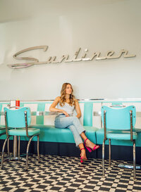 Senior portrait at Sunliner Diner in Gulf Shores, Alabama — sitting in a long booth with the
Sunliner Diner chrome logo above.