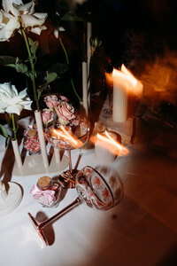 After dark details photos of table decor including florals, candles and pink champagne glasses. Styling by Sunshine Events by Lisa P