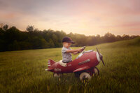 Charleston Baby Milestone Photographer -Baby explores and antique peddal plane during his Milestone Child Portraits in Charleston, SC