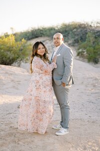 Parents from the Collins family posing together in the Las Vegas desert during golden hour, wearing formal attire in a romantic outdoor couples portrait session.