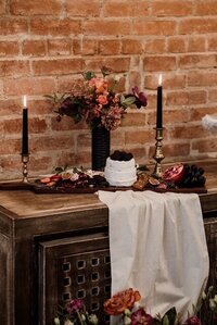 charcuterie board wedding venue candles surrounded florals