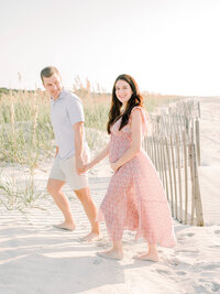 couple on the beaches of hilton head capturing maternity portraits