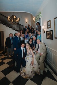bride and groom taking a family photo
