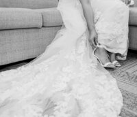 bride adjusting shoe wedding dress