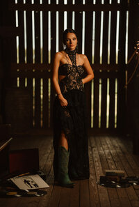 Senior portrait at Triple T Farms in Fruitdale, Alabama — standing in a barn with vinyl records
and a record player.