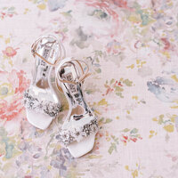 Bridal shoes detail shot on floral background