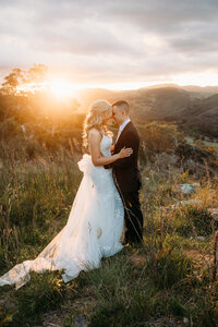 A wedding photo featuring the couple in front of an incredible sunset at Brindabella Hills Winery