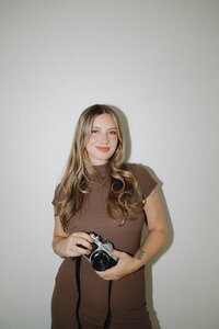 photographer holding film camera
