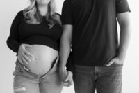 black and white image of pregnant woman and man holding hands- Metro Detroit Maternity Photography