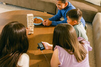 Overhead of a game night, the device and app in hand at the table