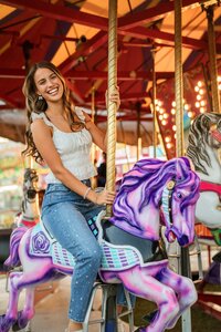 Senior portrait at the Greater Gulf State Fair in Mobile, Alabama — laughing while riding the
carousel.