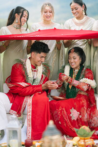 Bride and groom at Hindu Ceremony. Venue: Event field at Henley's Orchard. Florals by Flowergirl Cville. Navodita KC Photography.