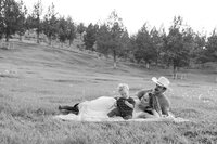 Lifestyle family photo captured in a grassy field in Bend, Oregon