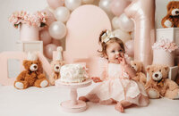 Charleston Cake Smash Photographer- Baby looks into the camera during Cake Smash Photos at Holy City Babies Portrait Studio in Charleston, SC.