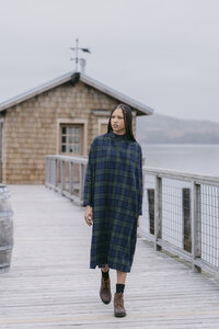 Navy and green plaid midi dress worn with boots on the boardwalk