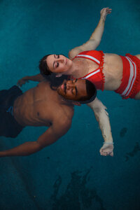 couple floating on their backs in the pool
