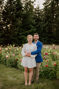 bride and groom standing in a flower garden
