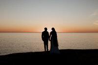 Bride and groom kissing together in a garden on their wedding day