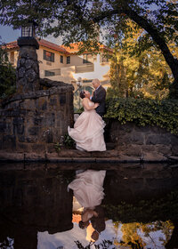Couple kissing near the water at the Columbia Gorge Hotel before their wedding