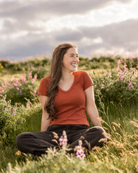 Girl sitting in a field of wildflowers at Tom McCall nature preserve.