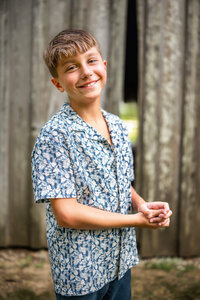 Smiling pre teen boy during extended family photography session in Eastern North Carolina