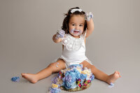 baby Violet playing with cake during fine art milestone portrait session at CG Photography North Hollywood