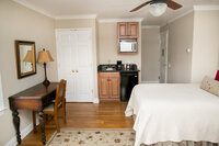 Cozy queen guest room with seating area and natural light at Crossed Keys Inn New Jersey