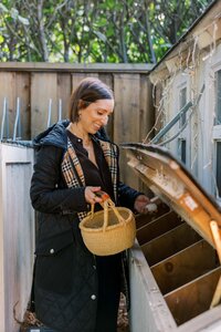 Leah Solivan grabbing fresh eggs from her chickens