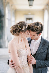 groom-hugs-bride-terrace-portrait