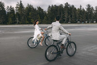couple eloping in tofino bc at mackenzie beach resort using beach bikes