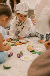Toddlers playing with fake food