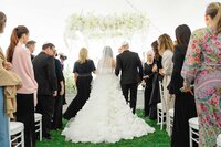 bride walks down aisle in Pnina Tornai designer dress