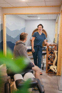 Chiropractor talking with patient.