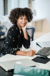 Business woman at desk posing for a photo.