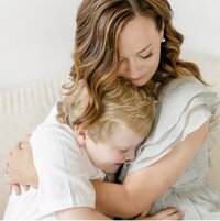 Mom snuggling with little boy 