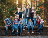 Extended Family portrait in autumn forest with warm golden light and fall colors in Eastern North Carolina