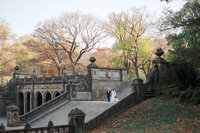 Sophisticated editorial wedding photography of a bride and groom walking down the grand Bethesda Terrace staircase in Central Park, NYC.