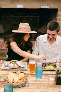 Couple sharing a meal beside the fireplace at Mustangs & Burro