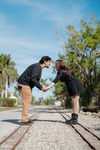 Engaged couple leaning in for a kiss in Lakes Park, Fort Myers Florida.
