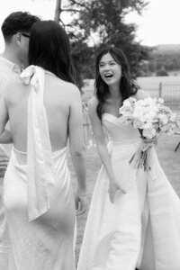 Real and unposed moment of a bride laughing with her bridesmaids, showcasing genuine emotions and documentary storytelling.