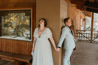Bride and groom holding hands during their first touch at their wedding venue at Deer Creek Mountain Camp