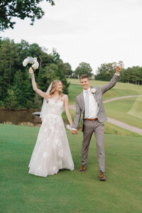 wedding couple celebrating after getting married at tpc sugarloaf in georgia