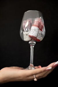 Studio detail shot of wine glass with floral artwork against black backdrop. Photograph by Yucaipa branding photographer Kaitlyn Dawn Photography.